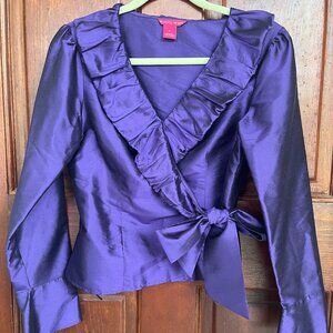 Taffeta wrap blouse with ruffle collar and side tie. Deep purple color